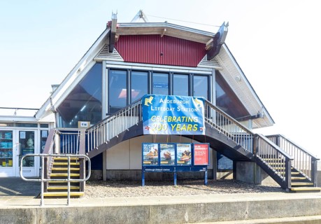 RNLI Lifeboat Station building on beach at Aldeburgh, Suffolk, England, UK - celebrating 200 years,