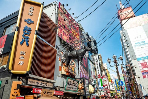 Lots of colorful signs in a pedestrian zone with shops and restaurants, Dotonbori, Osaka, Japan