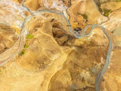 Steaming hot springs and colourful rhyolite mountains, aerial view, Hveradalir geothermal area,