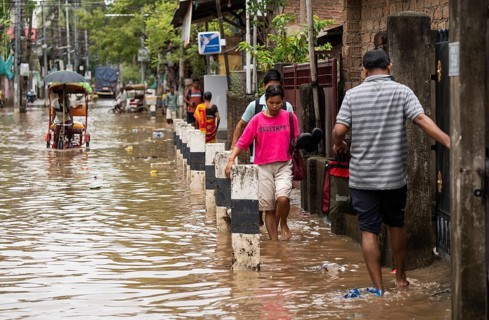Commuters wade through a flooded street after heavy rains in Guwahati, India on April 28, 2025