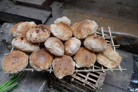 Freshly oven baked traditional Baladi flat bread, for sale in Cairo, similar to pitta bread is a