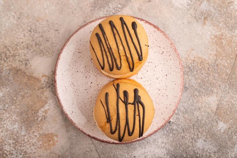 Caramel Cream Cakes on brown concrete background, top view, flat lay, close up