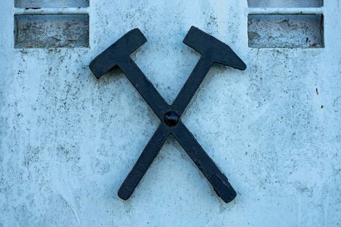 Mallet and chisel, mallet and iron, symbol of mining on a mine car, lorry for transporting lignite