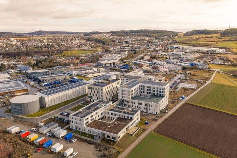 Industrial area in rural area with fields and hills in the background, shortly in front of opening,