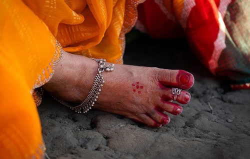 Hindu devotees perform rituals as they offer prayers to the Sun god in the bank of Brahmaputra