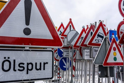 Storage for traffic signs in the yard of a road maintenance department, various signs with