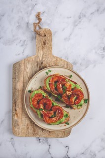 Sandwiches with avocado and caramelized shrimp, micro-greens, breakfast, on a plate, top view,