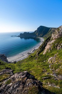 View of coastal landscape, cliffs with peak Måtind or Måtinden, Høyvika beach and sea, hike to the