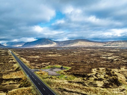 Moors and Road A82 over Glencoe Valley from a drone, Highland, Scotland, United Kingdom