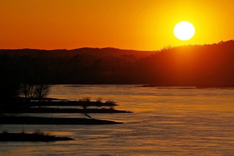 Sunset over a river with islands and orange-coloured sky, Elbe, Dömitz, Wendland, Lower Saxony,