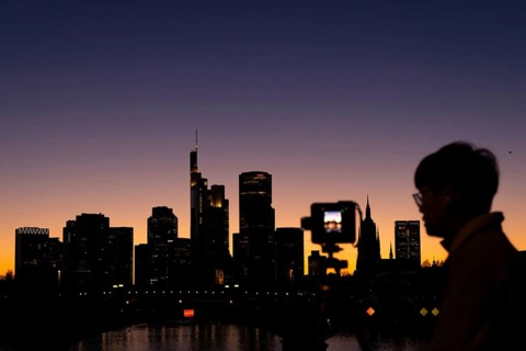 The silhouette of Frankfurt's banking skyline stands out in the evening against the residual light