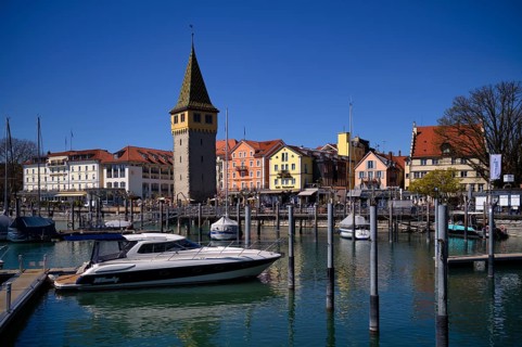 Boat dock, yachts, boats are moored in the harbor, behind it Mangturm, Hotel Bayerischer Hof, Hotel