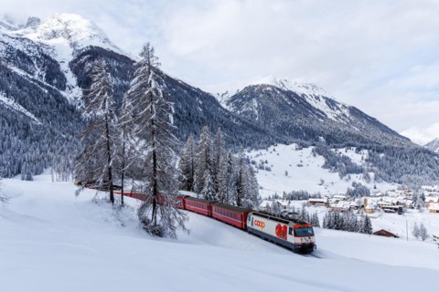 Rhaetian Railway train on the Albula railway Passenger train in the Alps in Bergün, Switzerland