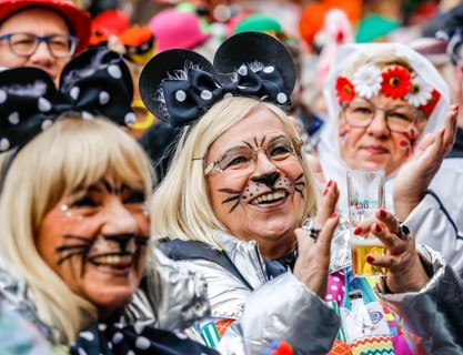Colourfully costumed carnivalists celebrate carnival in Cologne, on Weiberfastnacht the street