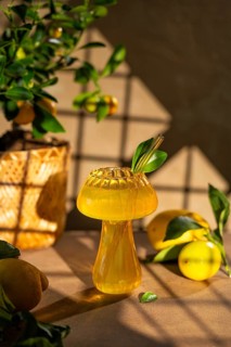 A bright and refreshing lemon drink served in an elegantly designed glass, complemented by fresh