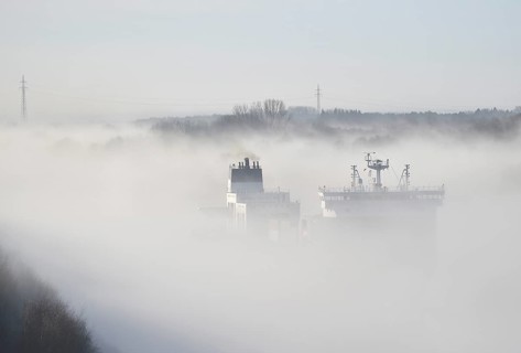 Container ship CMA CGM TIVOLI sailing in fog in the Kiel Canal, NOK, Kielkanal, Kiel Canal,