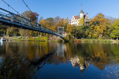 Gattersburg and suspension bridge over the Mulde in autumn, Grimma, Saxony, Germany