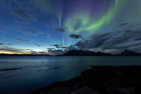 Northern lights at dawn over Sørfolda Fjord near Kjerringøy between Bodø and Sørfold in Norway