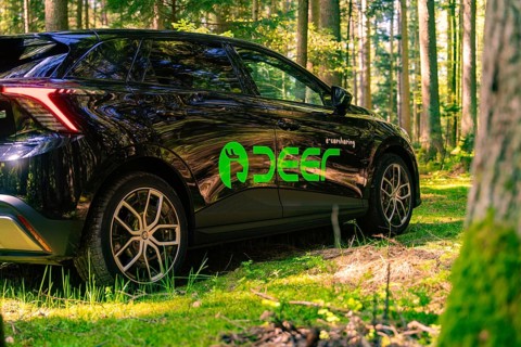 Side view of a black car in the sunlit forest, Deer E- Carsharing, Calw, Black Forest, Germany