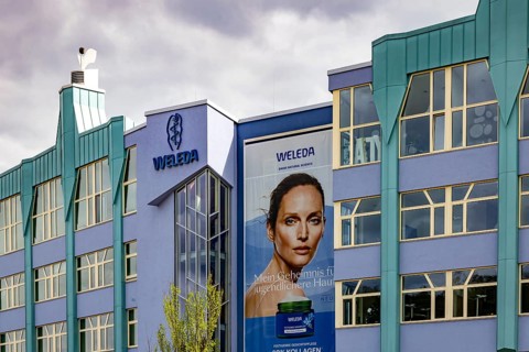 Weleda logo on the company building. Schwäbisch Gmünd as a business location. Weleda AG is a Swiss
