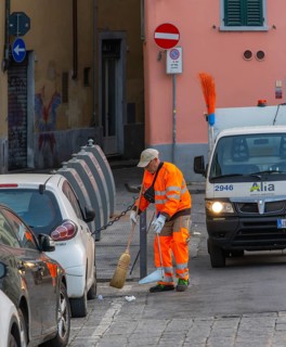 City cleaning workers wearing orange-colored protective clothing working in the city in the