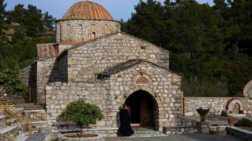 Stone monastery in a natural setting with a striking round roof and entrance, Thari Monastery, Moni