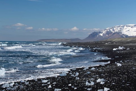 Little icebergs and crushed ice on the black beach at Joekulsarlon glacial lake