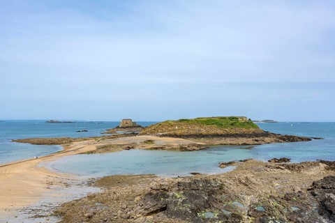 A picturesque view of the uninhabited tidal island of Grand Bé at low tide in the Bay of Saint-Malo