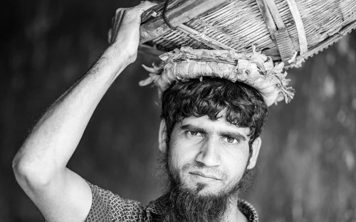 Portrait of a man with a basket on his head, monochrome, Dhaka, Bangladesh