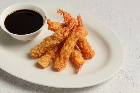 Fried shrimp, peeled in tempura, soy sauce, close-up