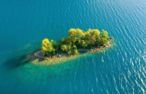 Bird's eye view of the chive island in the turquoise waters of Lake Walen in the canton of St.