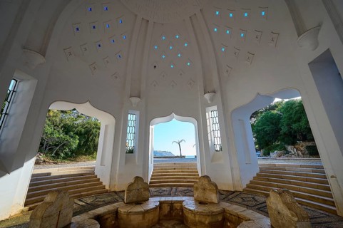 Interior of a dome with seating and stepped structure, illuminated by blue light patterns, thermal