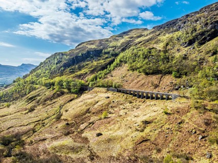 Mountains over Glen Ogle Viaduct from a drone, Road A85, Scotland, UK