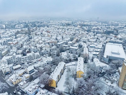 Snow-covered city from above with dense residential buildings and streets, Sindelfingen, Germany