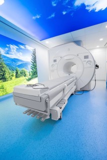 An MRI room with a modern design and a calming landscape on the wall, radiology in the new health