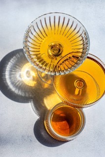 Elegant crystal glasses filled with Georgian amber wine, showcasing its rich hue and intricate