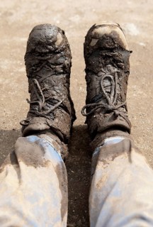Hiking boots smeared with mud after gorilla tracking, Virunga Volcano Mountains, Parc National des