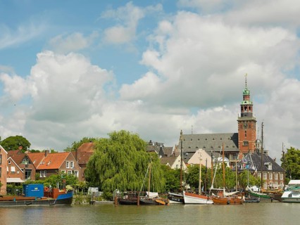 Museum harbour in Leer, traditional ships, in the background the scale and the old town hall,