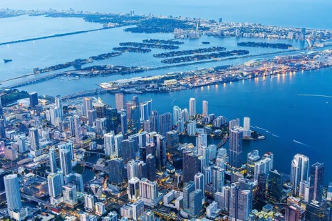 Aerial view of Miami skyline with skyscrapers Downtown Brickell and Miami Beach at night in Miami,
