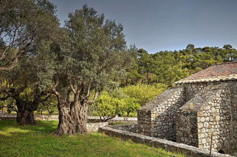 HDR, partial view of a stone church with surrounding trees and nature, Monastery Thari, Moni Thari,