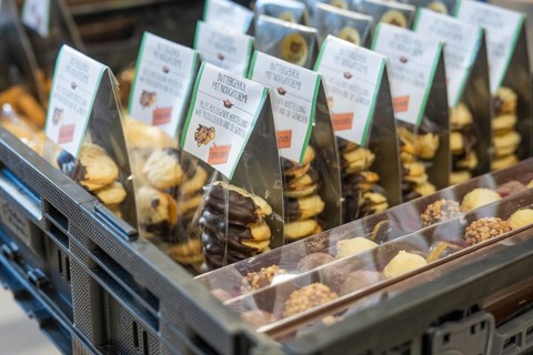 Different types of packaged cookies piled up with chocolate