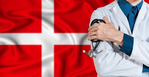 Doctor with stethoscope on Denmark flag. Doctor holding stethoscope on Denmark flag