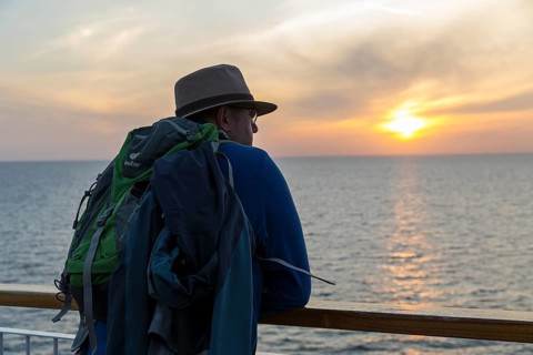 Man watching sunset on the ferry crossing from Rostock in Germany to Trelleborg in Sweden