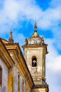 Windows and bell tower of an old beautiful baroque church in the city of Ouro Preto