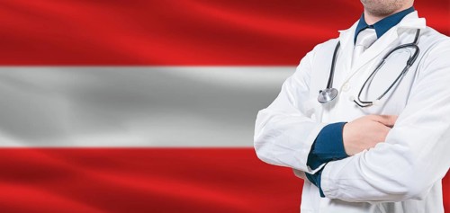 Austria Health Care concept. Male doctor on Austria flag. Doctor with crossed arms on Austria flag