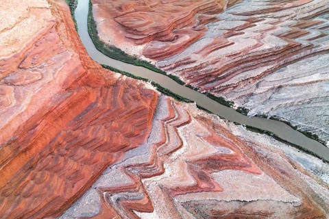 Captivating aerial shot of Rio San Juan weaving through the striking red and white geological