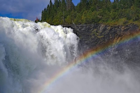 Close-up of a mighty waterfall with a shimmering rainbow, Tännforsen, Jämtland, Sweden