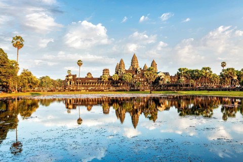 Cambodian landmark Angkor Wat with reflection in water on sunset. Siem Reap, Cambodia