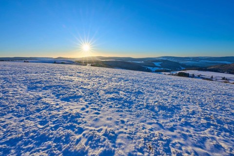 Clear sky over snowy winter landscape, sun on the horizon, winter, Wasserkuppe, Gersfeld, Rhön,