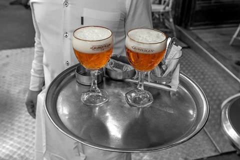 Service brings two beers on a tray, black and white, Paris, France